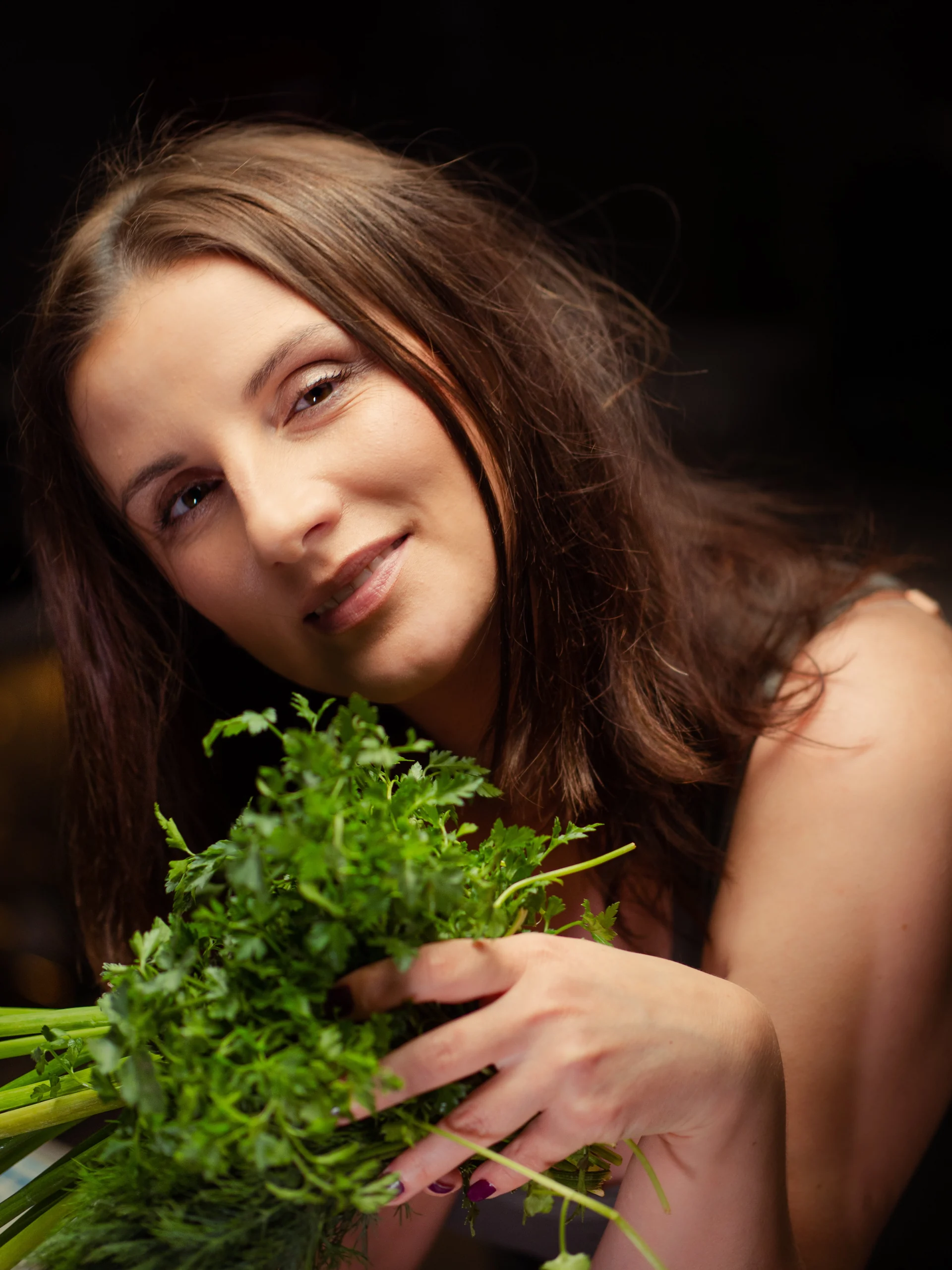 Olga Kindel holding fresh herbs